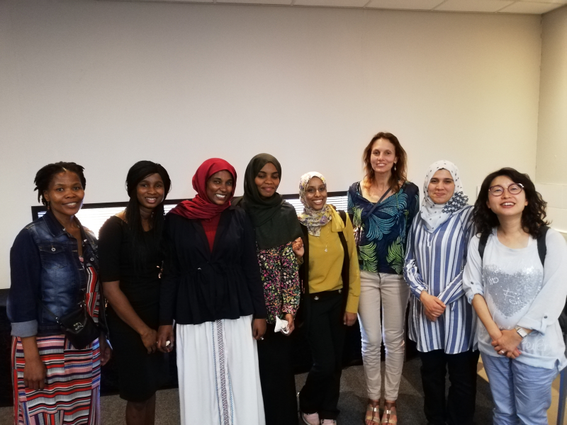 Isabelle Chalendar surrounded by young female mathematicians at a CIMPA school in Johannesburg.